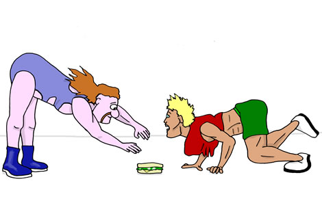 Two men move towards a sandwich on the ground between them